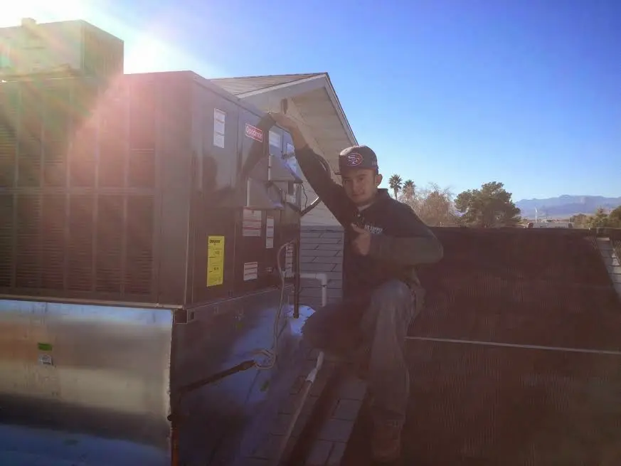 HVAC technician performing Boiler Repair on a rooftop unit in Bath